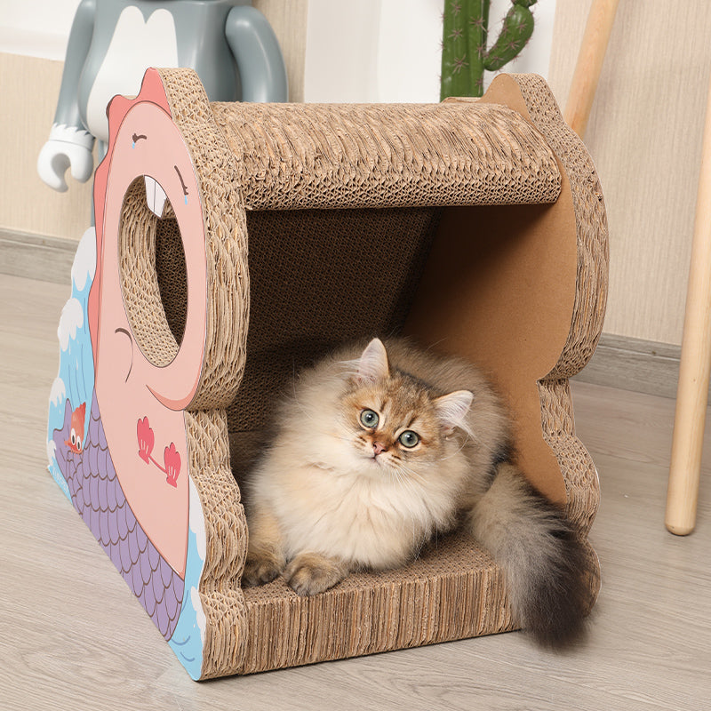 A cat is sitting inside of a Mermaid cat house with scratch board