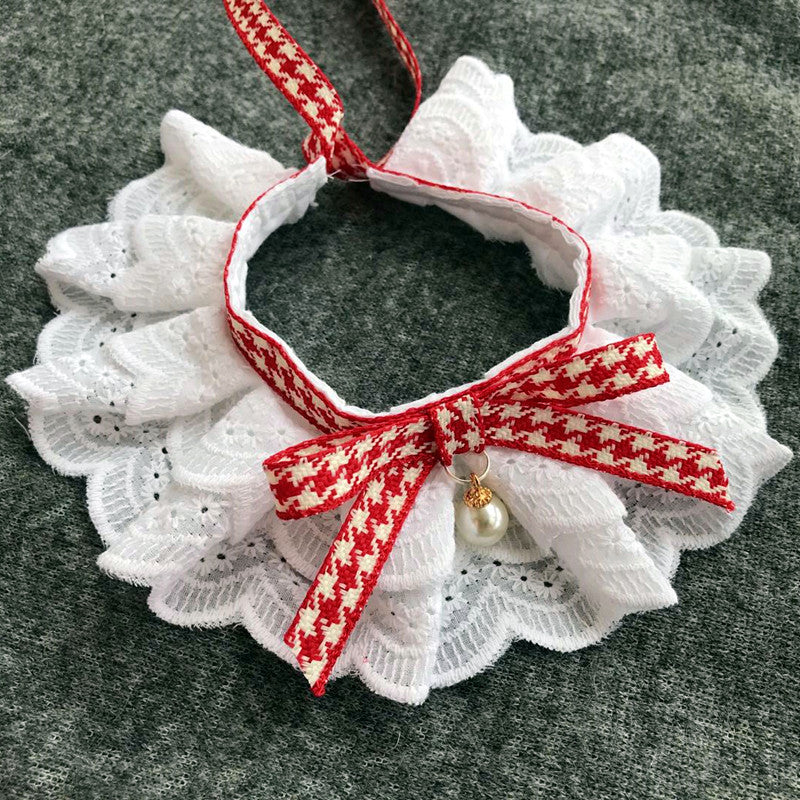 A red and white pet bib made of lace