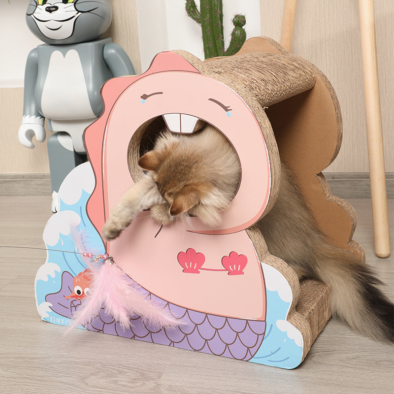 A cat is playing inside of a Mermaid cat house with scratch board