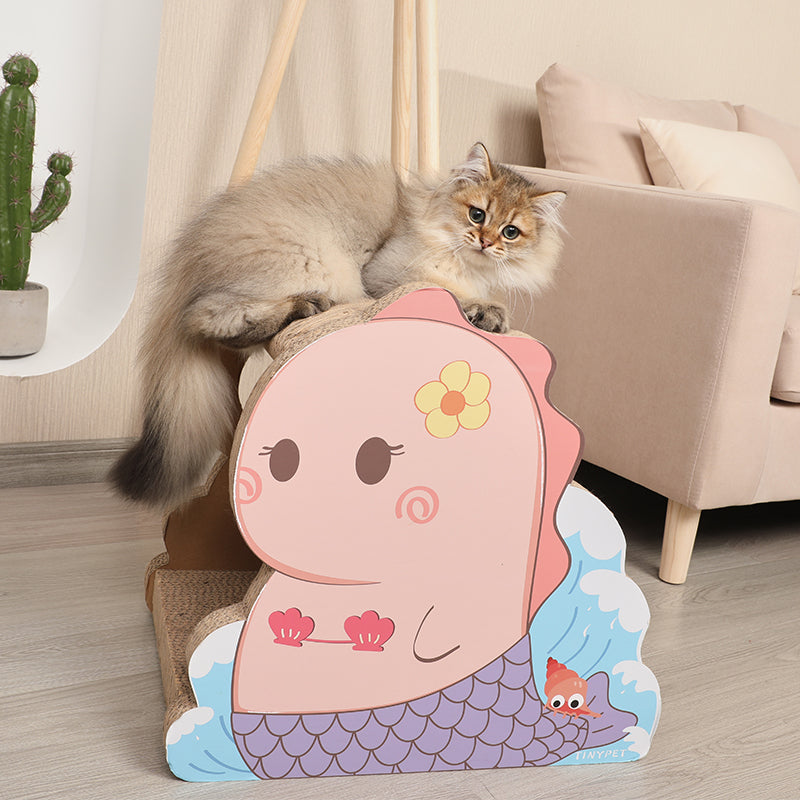 A cat is sitting on a Mermaid cat house with scratch board